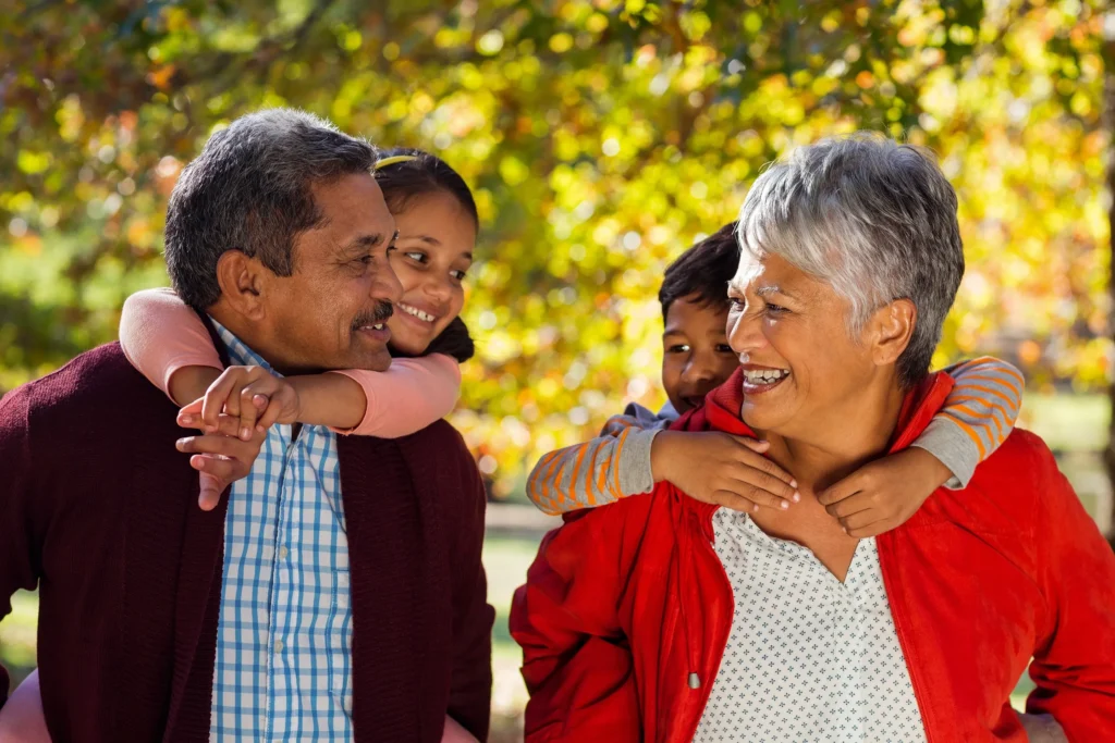 Two grandparents on a walk with their grandchildren.