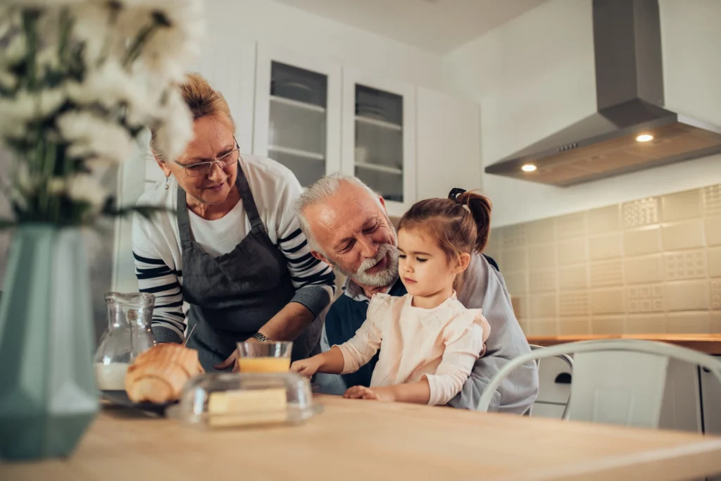 Grandparents baking with their granddaughter.