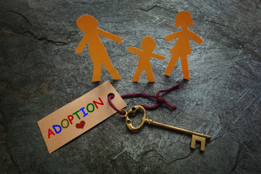 A tag attached to a key that says adoption.