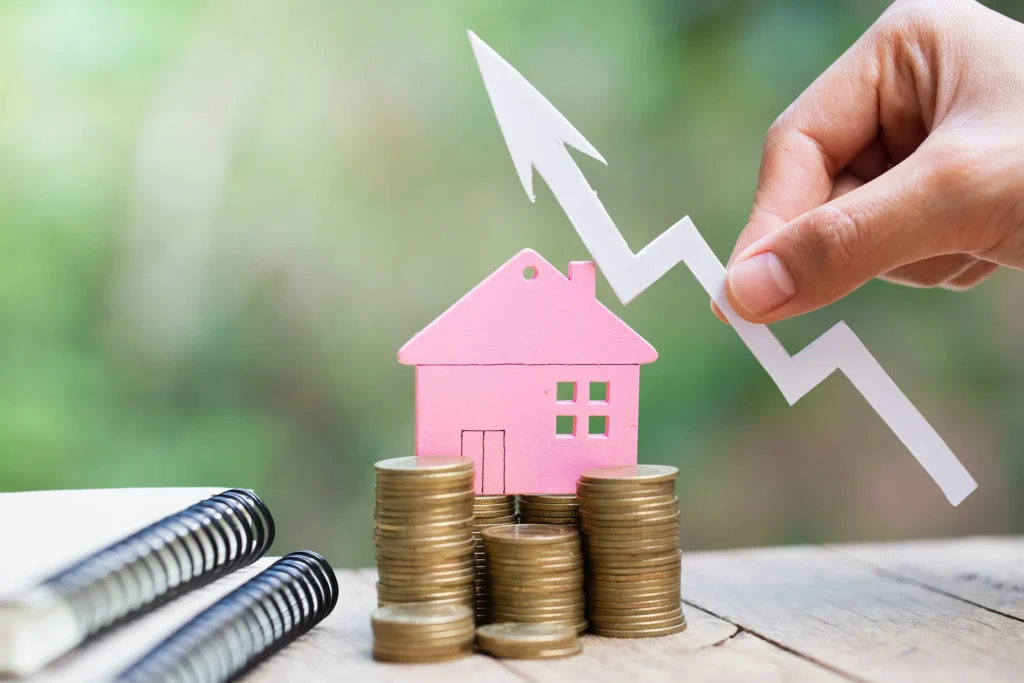 A house with stacks of coins and a line graph going up.