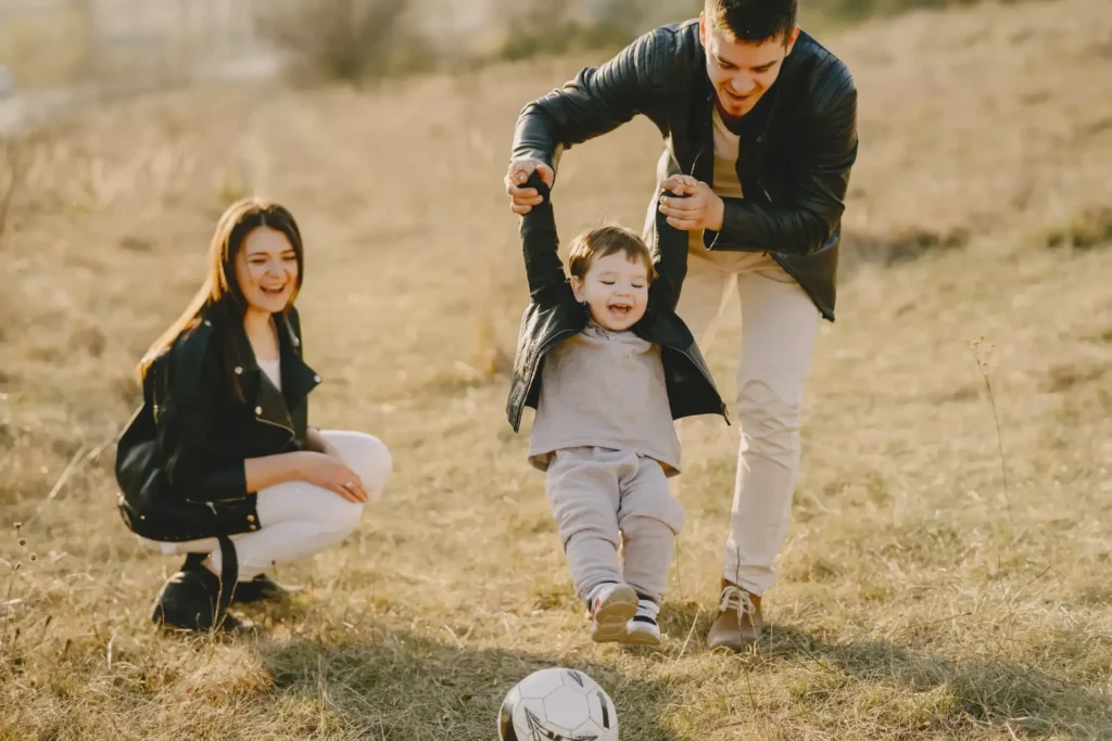 A mom and dad playing with their child. 