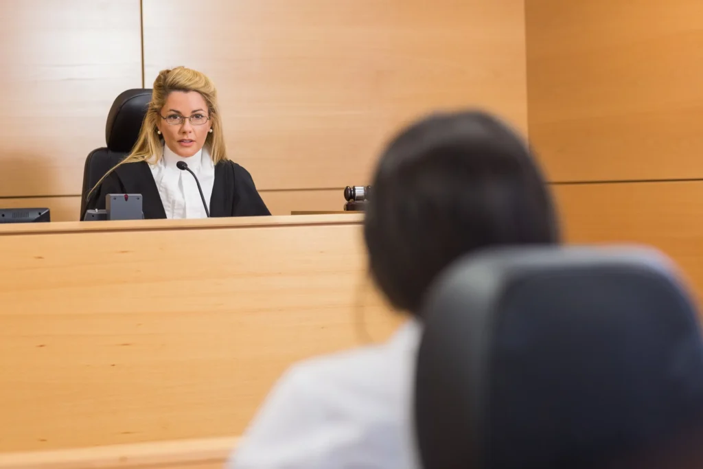 A person speaking with a judge in a court of law.
